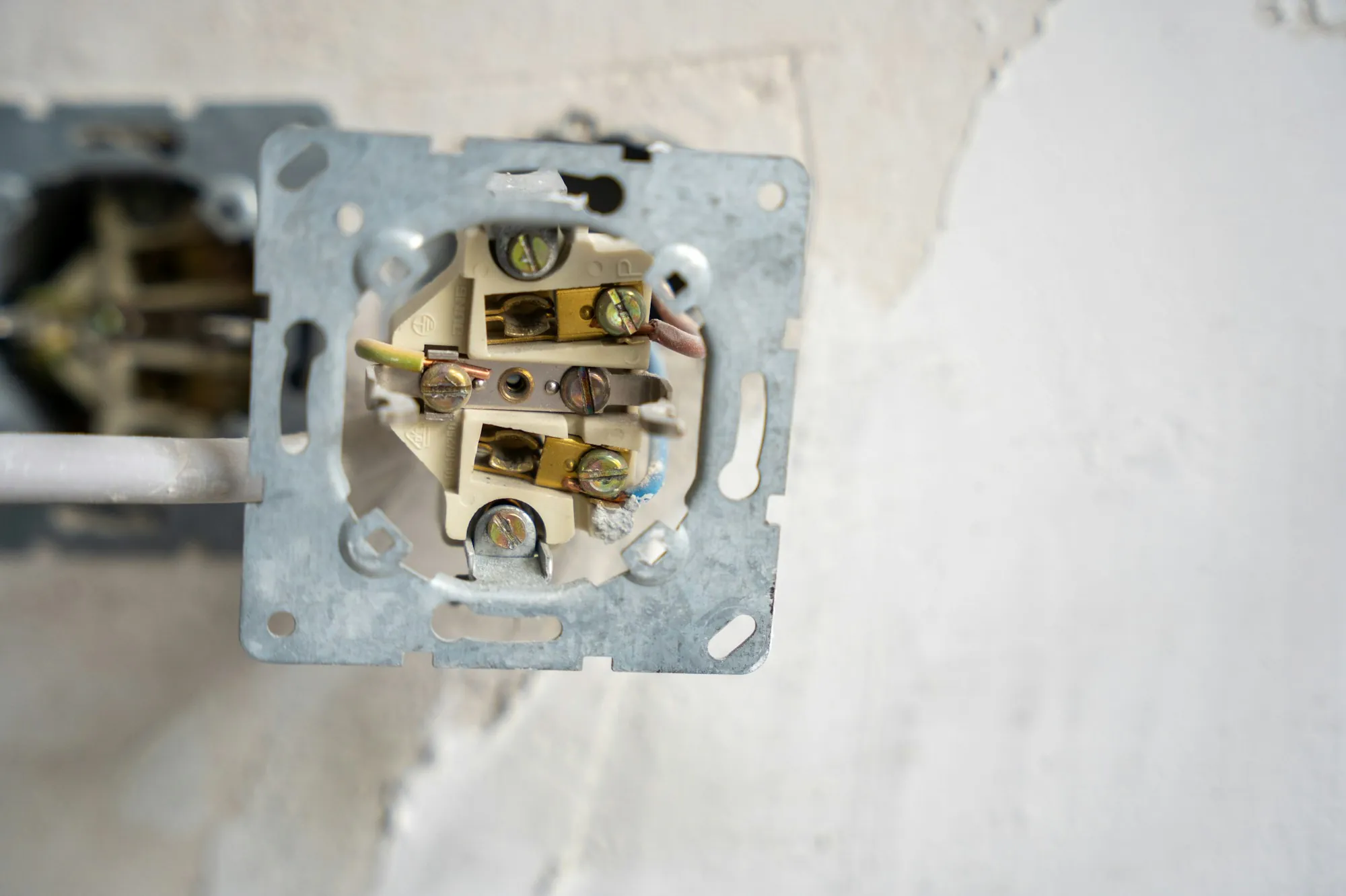 Old wall receptacle box opened for new wiring