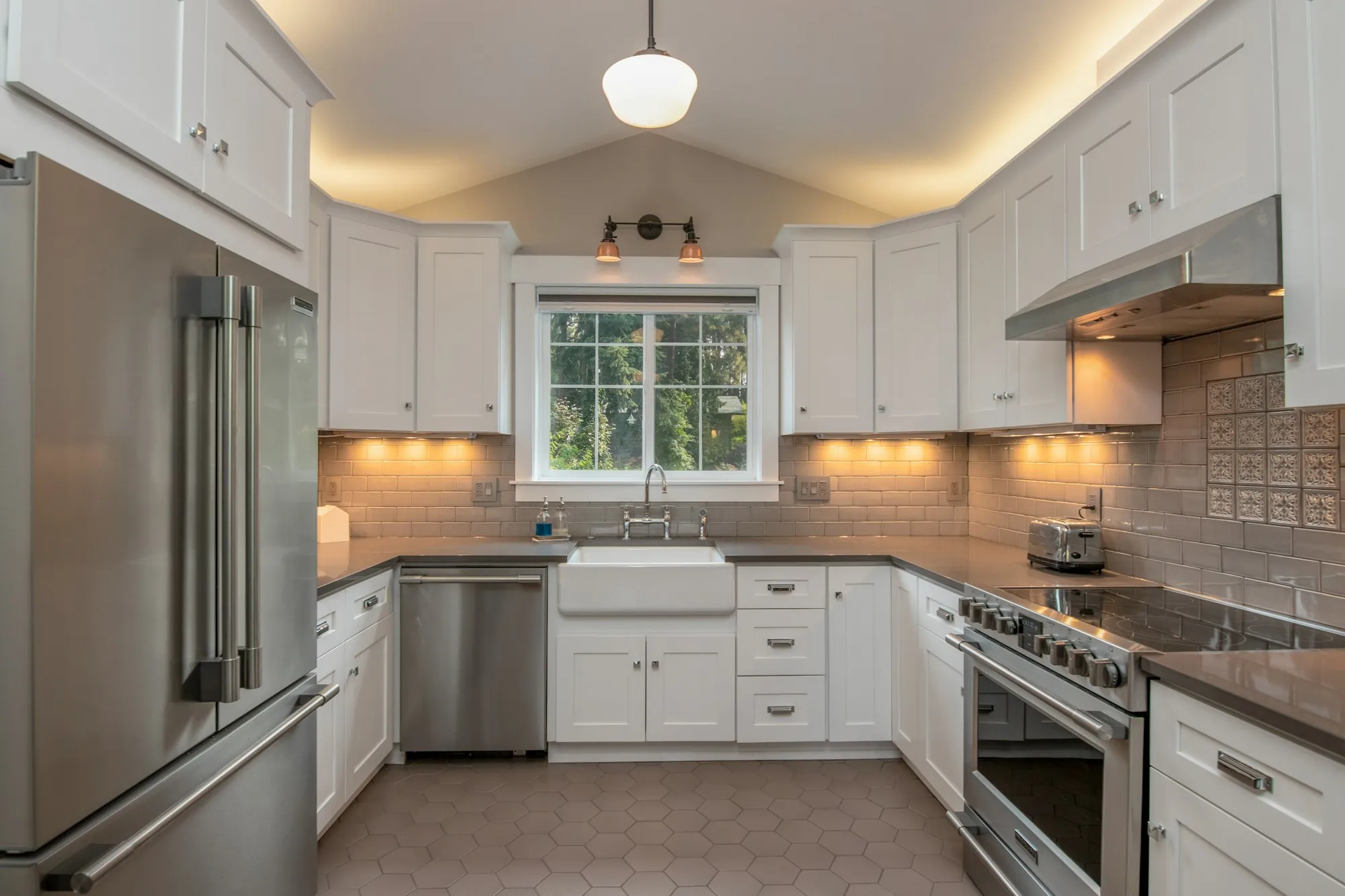 Newly finished kitchen with white cabinets and under-cabinet lighting
