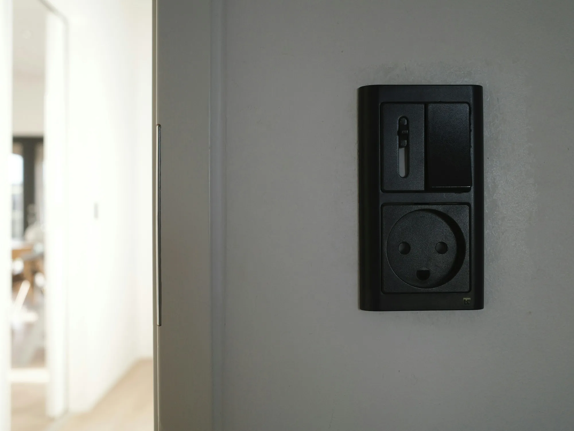 Light switch plate on a plain white wall