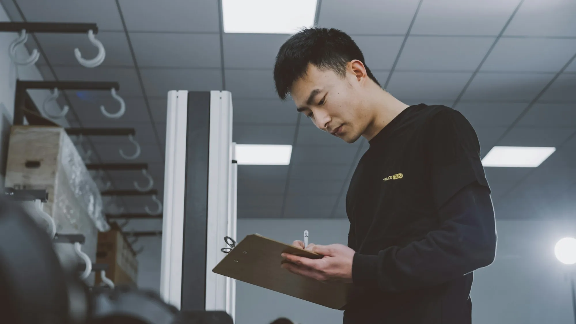 Electrician reviewing notes on a clipboard during a home visit